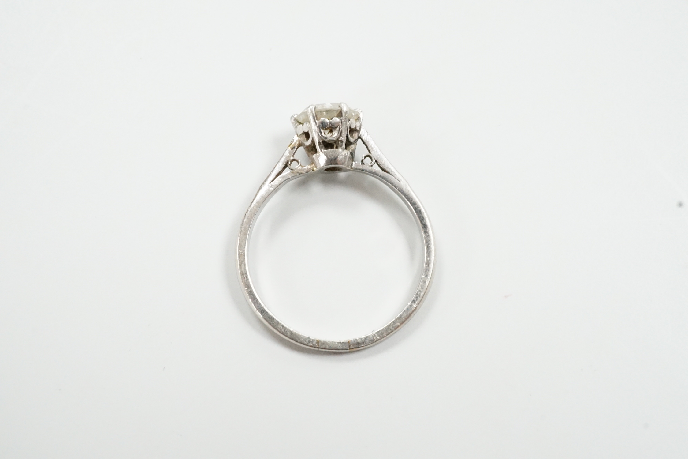 A white metal (stamped plat) and solitaire diamond set ring, size M, gross weight 3.1 grams